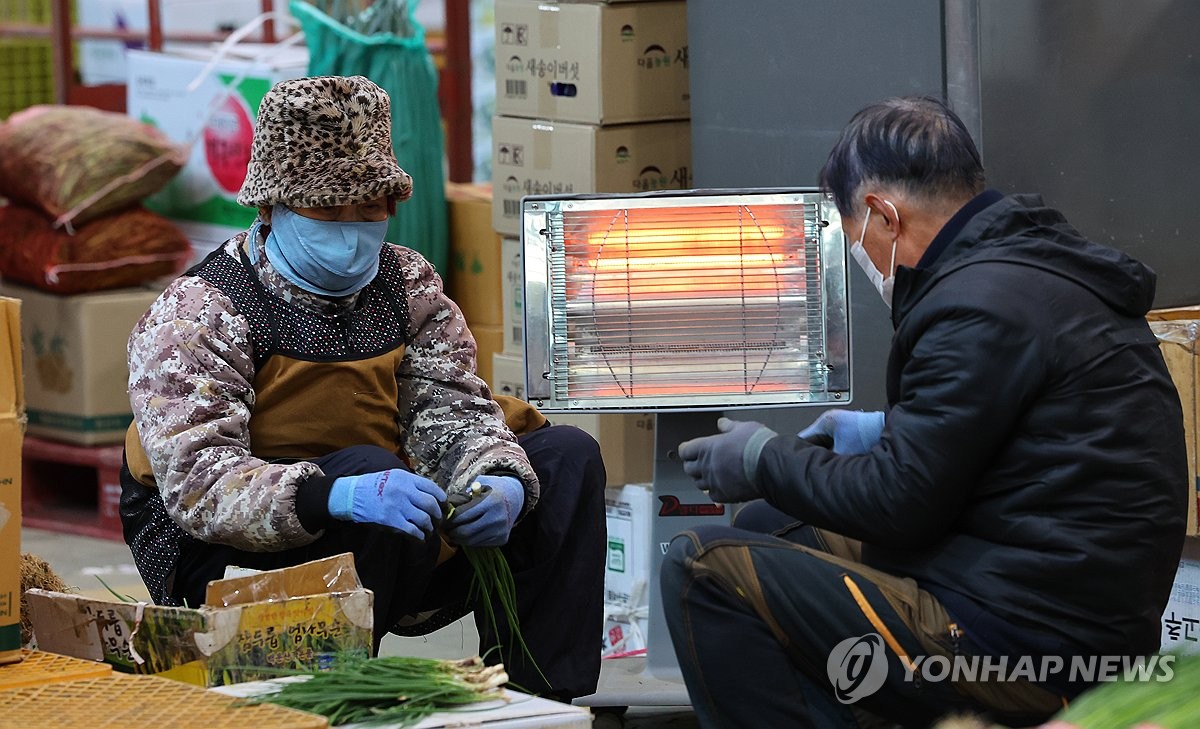 난로에 몸 녹이는 상인들